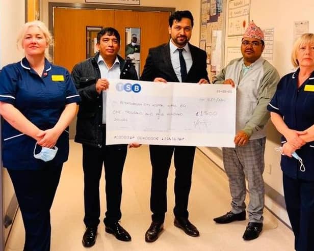Paul Sharma presents the cheque for £1,500 to Ward 14 at PCH.
