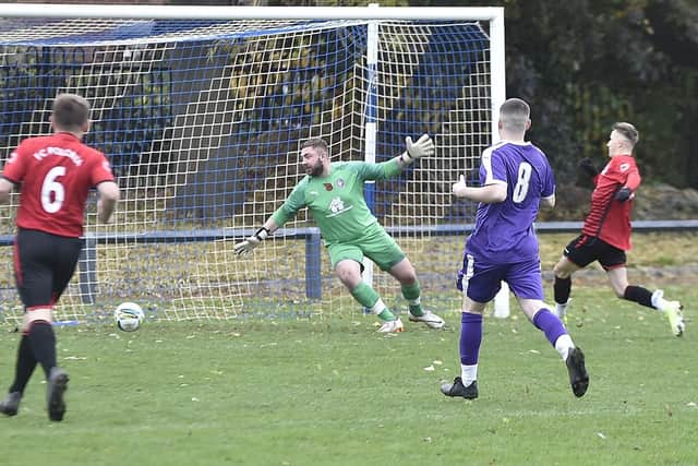 Polonia open the scoring in a Peterborough League Division Two clash with Stanground Sports (purple). Photo: David Lowndes.