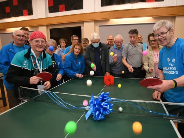 Andy Cassey (head of Parkinson's table tennis clubs) and Graham Wild (a local volunteer) with club members at the launch of the Peterborough Parkinson's Ping Pong club at the Salvation Army Citadel, Bourges Boulevard EMN-211211-162535009