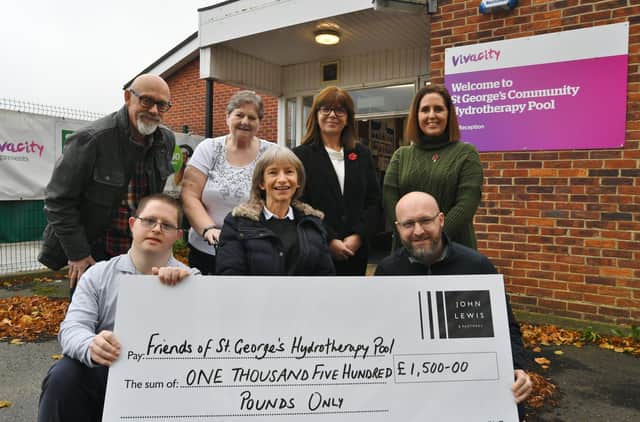 John Lewis staff Christine Hutchins and Sam Ring  present a cheque to Karen and Rob Oldale for the Friends of St George's Hydrotherapy Pool with volunteers Andrew King, Sue Jolly and Steven Luker. EMN-211111-135221009