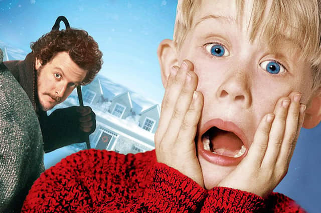 The drive-in cinema is showing  Home Alone (1990).