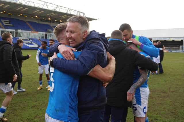 Posh boss Darren Ferguson celebrates promotion from League One last season with Dan Butler.