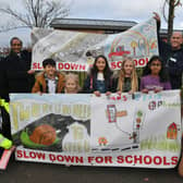 The new road safety posters outside Hampton Hargate primary school with the pupils who did the artwork, local councillors and council officials. EMN-211119-144356009