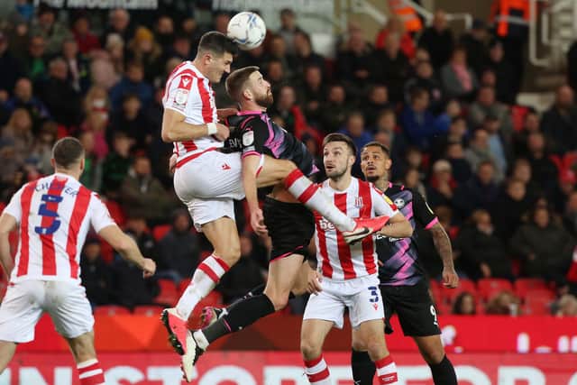 Mark Beevers of Peterborough United battles in the air with Danny Batth of Stoke City. Photo: Joe Dent/theposh.com.