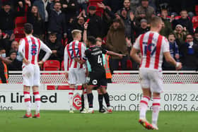 Sam Surridge of Stoke City is shown a straight red card by referee Eddie Wolstenholme. Photo: Joe Dent/theposh.com.