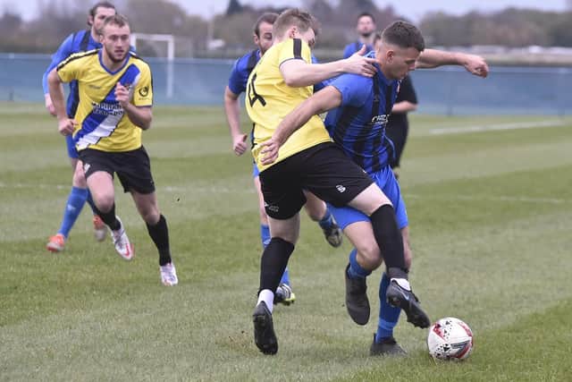 Match action from the FA Vase tie between Whittlesey Athletic (blue) and Worcester City. Photo: David Lowndes.