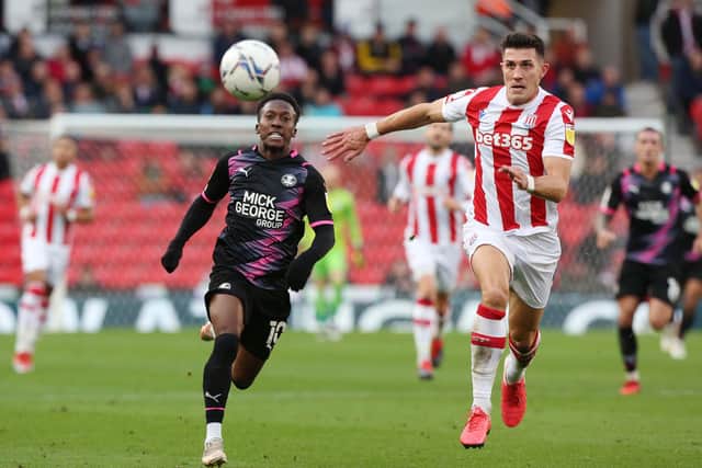 Siriki Dembele of Peterborough United in action with Danny Batth of Stoke City. Photo: Joe Dent/theposh.com.