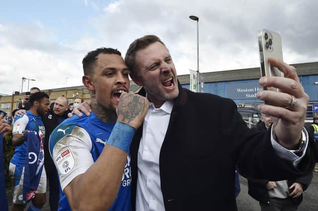 Posh chairman Darragh MacAnthony and striker Jonson Clarke-Harris celebrate promotion from League One last season.