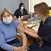 Mass vaccination centre at the City Care Centre, Thorpe Road.  Jill Plant receives her jab from Dr Gillian Mitchell. EMN-210127-141653009