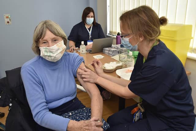 Mass vaccination centre at the City Care Centre, Thorpe Road.  Jill Plant receives her jab from Dr Gillian Mitchell. EMN-210127-141653009