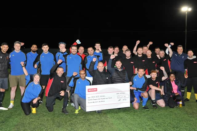 Mears present the cheque at the friendly football tournament.