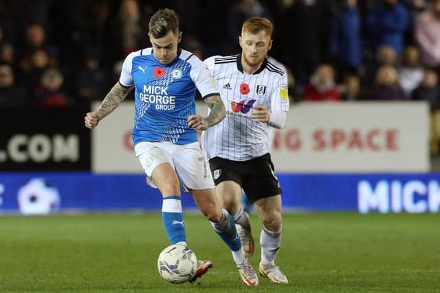 Sammie Szmodics of Peterborough United in action with Harrison Reed of Fulham. Photo: Joe Dent/theposh.com.