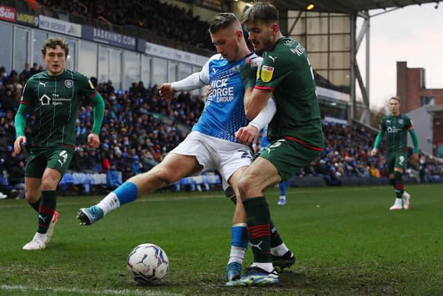Kai Corbett of Peterborough United in action with Liam Kitching of Barnsley. Photo: Joe Dent/theposh.com