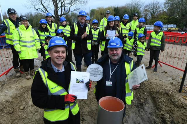 Staff and pupils from Bishop Creighton School with Ross Renton (principal), Mayor Nik Johnson and Wayne Fitzgerald with a time capsule to be buried on the ARU site at Bishop's Road.