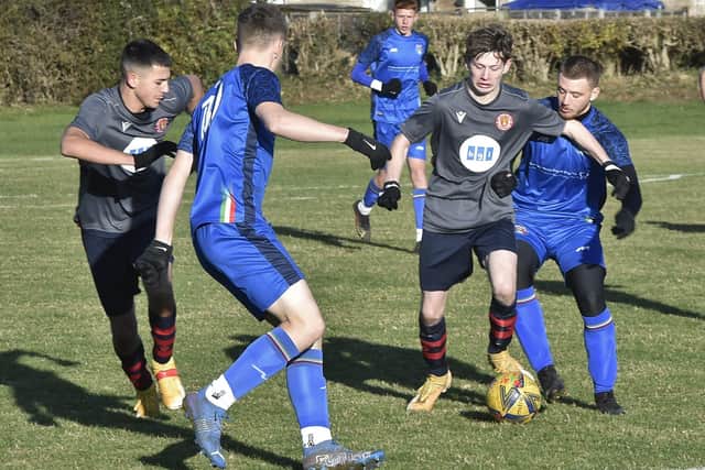 Action from Deeping United's win at ICA Sports (blue) in Under 18 Division One of the Peterborough Youth League.  Photo: David Lowndes.