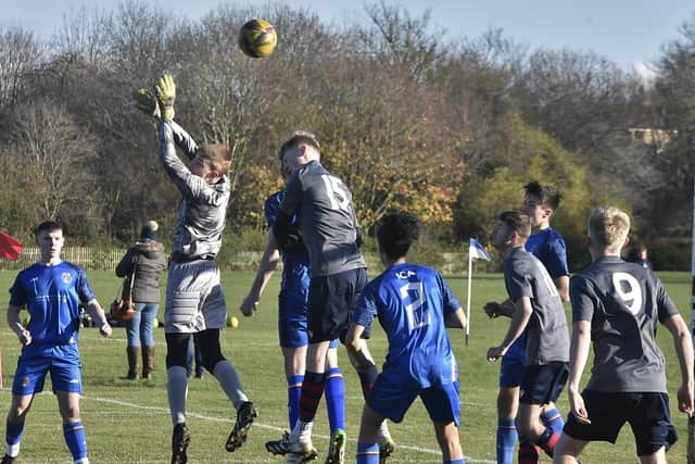 Action from ICA Sports Under 18s (blue) v Deeping United at Ringwood.  Photo: David Lowndes.