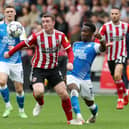 Siriki Dembele of Peterborough United in action with John Fleck of Sheffield United at Bramall Lane earlier this season.