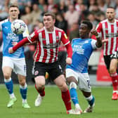 Siriki Dembele of Peterborough United in action with John Fleck of Sheffield United at Bramall Lane earlier this season.