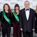 NSPCC volunteers are pictured with television celebrity Christopher Biggins