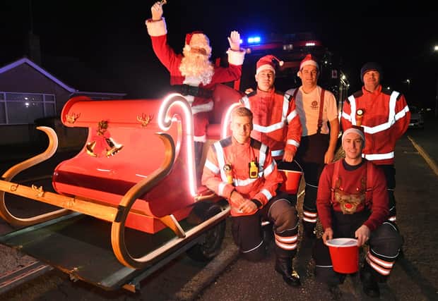 Firefighters from Peterborough Volunteer fire service with the re-vamped Eye Christmas Siiegh EMN-211012-200340009