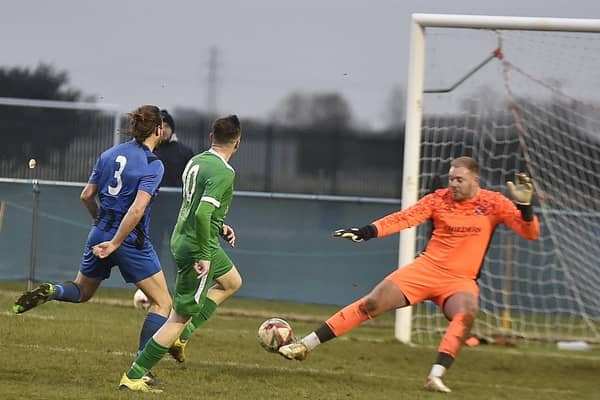 Newport Pagnell score past Whittlesey goalkeeper Aaron Bellairs. Photo: David Lowndes.