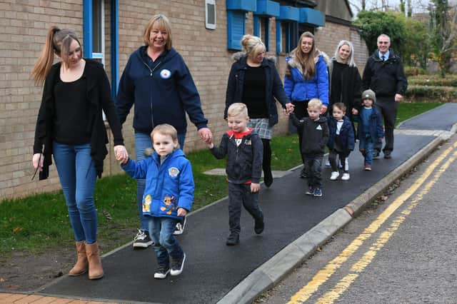 Cllr. Graham Casey with staff and children from the Herlington Pre-School using their new path. EMN-211213-114605009