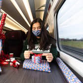 Professional gift wrapper Finn Drumgoole wraps presents for LNER customers to launch the rail operator's complimentary 'Rail Wrapping' service. Pic:David Parry/PA Wire EMN-211214-110142005