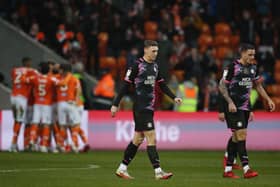 Jack Taylor and Oliver Norburn of Peterborough United cut dejected figures as Blackpool celebrate their equalising goal. Photo: Joe Dent/theposh.com.
