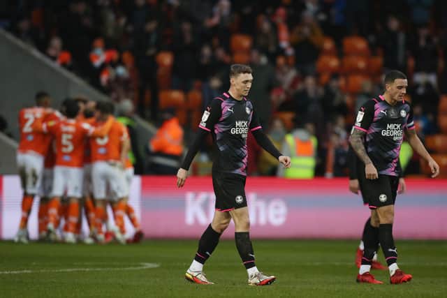 Jack Taylor and Oliver Norburn of Peterborough United cut dejected figures as Blackpool celebrate their equalising goal. Photo: Joe Dent/theposh.com.