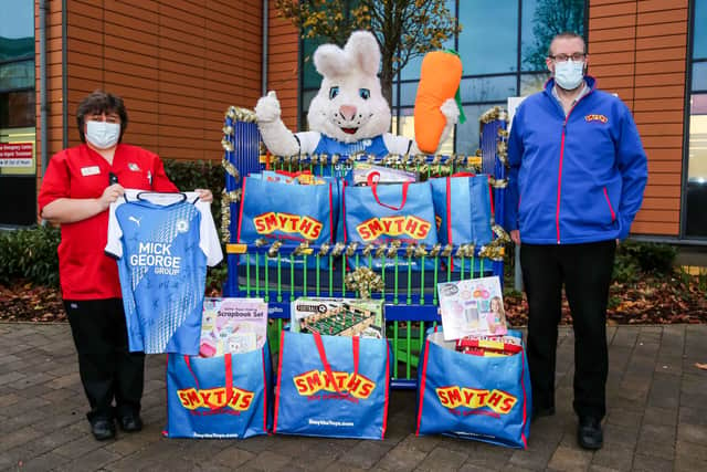 Posh mascot Peter Burrow and Smyths Toys employees deliver toys to Peterborough City Hospital.