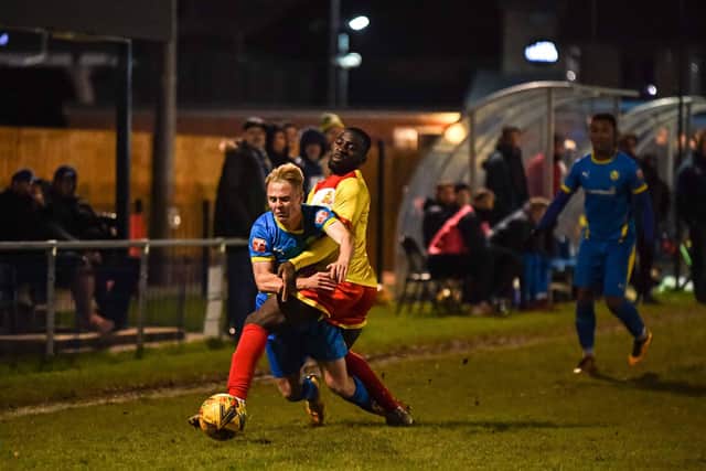 Liam Bennett (blue) in action for Peterborough Sports against Banbury. Photo: James Richardson.