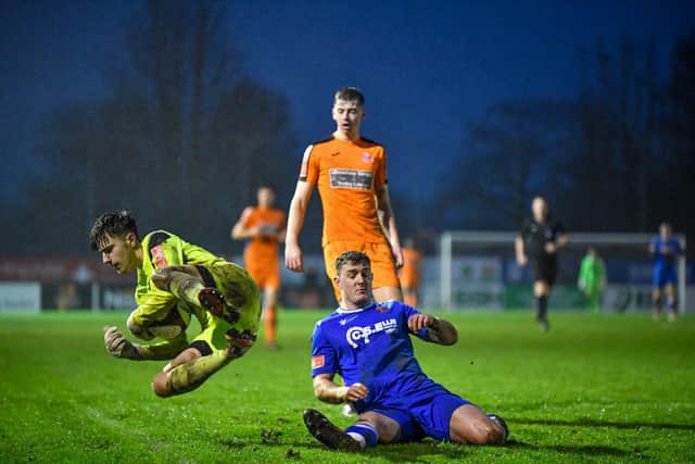 Yaxley goalkeeper Will Lakin makes a brave save at Stamford AFC. Photo: James Richardson.