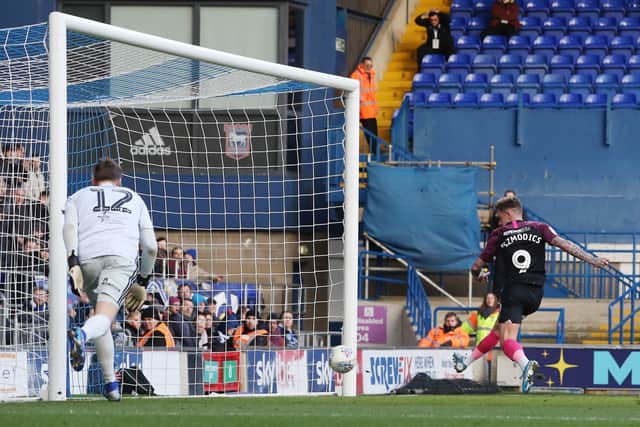 Sammie Szmodics scores for Posh after a blunder by Ipswich goalkeeper Will Norris.