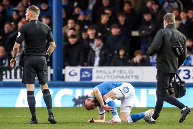 Dan Butler is injured early in the Posh game against Millwall.
