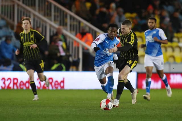 Siriki Dembele of Peterborough United battles with Paul Coutts of Bristol Rovers. Photo: Joe Dent/theposh.com.