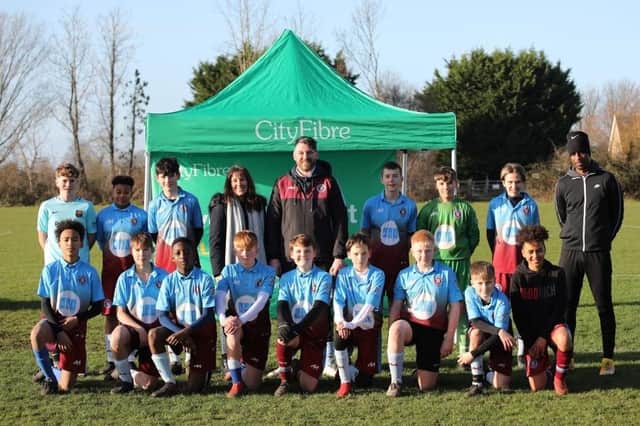 Rebecca Stephens, CityFibre’s Regional Partnership Director and City Manager for Peterborough, with the under 13s team at Thorpe Wood Rangers FC before the team won their league on Sunday (January 9).