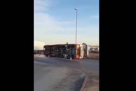 The overturned lorry on the A605.