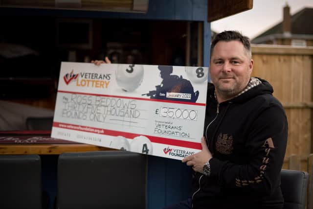 Ross Beddows with his £35,000 cheque