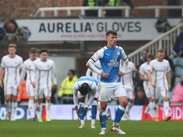 Harrison Burrows of Peterborough United is disappointed as Coventry City celebrate a goal. Photo: Joe Dent/theposh.com.