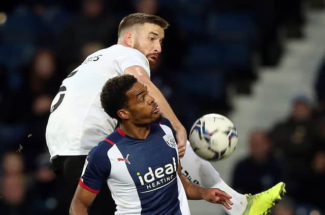 Mark Beevers of Peterborough United battles with Grady Diangana of West Bromwich Albion. Photo: Joe Dent/theposh.com.