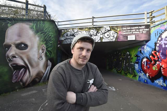 Street artist Nathan Murdock with other work just off Frank Perkins Parkway EMN-190320-165702009