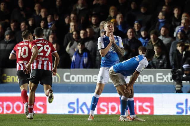 Frankie Kent and Nathan Thompson of Peterborough United look dejected after Billy Sharp of Sheffield United scores the opening goal of the game. Photo: Joe Dent/theposh.com.