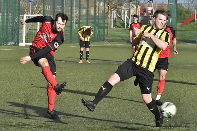 Zack Fisher (red) in action for Netherton against Crowland. Photo: David Lowndes.