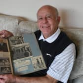 Former  player Peter Deakin pictured at his home in Longthorpe this week looking through an old scrapbook on Peterborough United games in the 60's.