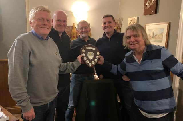 The picture shows Alan Jones, co-organiser, presenting the trophy to The Walnut Tree team, left to right: John Yardy, Keith Fowler, Steven Toms and Danny Knight.