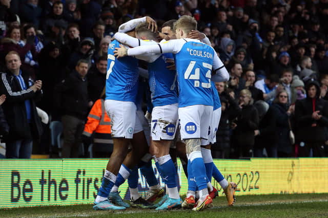 Peterborough United players celebrate the second goal of the game against Queens Park Rangers. Photo: Joe Dent/theposh.com.