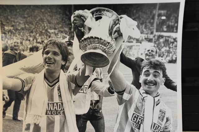 Micky Gynn (right)  lifts the FA Cup at Wembley when a Coventry City player.