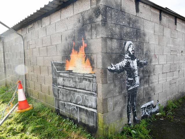Banksy's Season's Greetings which depicts a message about the impact of pollution on communities and appeared on the outside of a steelworker's private garage in Taibach, Port Talbot on December 19 2018. pa-new/ARTS Banksy  19040717.JPG