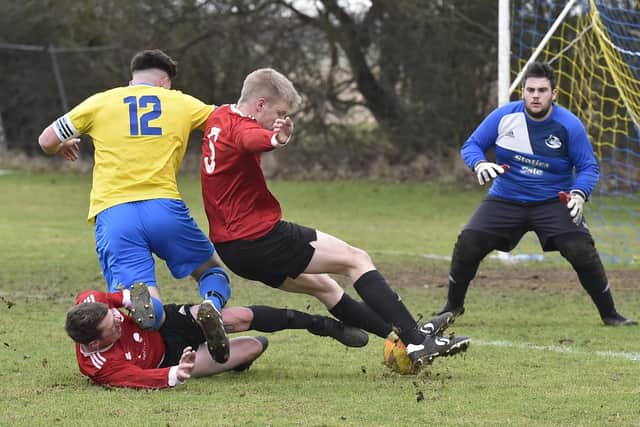 Sawtry (yellow) on their way to maintaining a perfect winning record in Division Three of the Peterborough League with a 2-1 success over Tydd Reserves. Photo: David Lowndes.