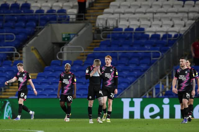 Peterborough United players cut dejected figures after Cardiff City score their second goal of the game. Photo; Joe Dent/theposh.com